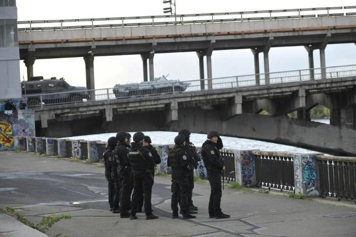 A large number of police cars and armed personnel carriers were at the scene, while special forces and snipers guarded the bridge after the man used his vehicle to block the bridge across the Dnipro river