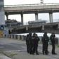 A large number of police cars and armed personnel carriers were at the scene, while special forces and snipers guarded the bridge after the man used his vehicle to block the bridge across the Dnipro river