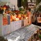 People hold portraits as they stand beside lighted candles placed in memory of murdered journalist Daphne Caruana Galizia on the sixth month anniversary of her death at a makeshift memorial outside the law courts in Valletta, Malta on April 16, 2018