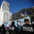 Riot police stand by as protesters camp outside the Social Development Ministry building in Buenos Aires