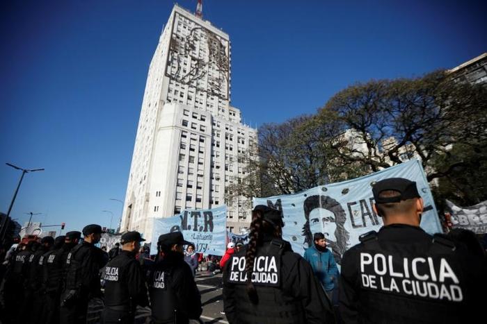 Riot police stand by as protesters camp outside the Social Development Ministry building in Buenos Aires