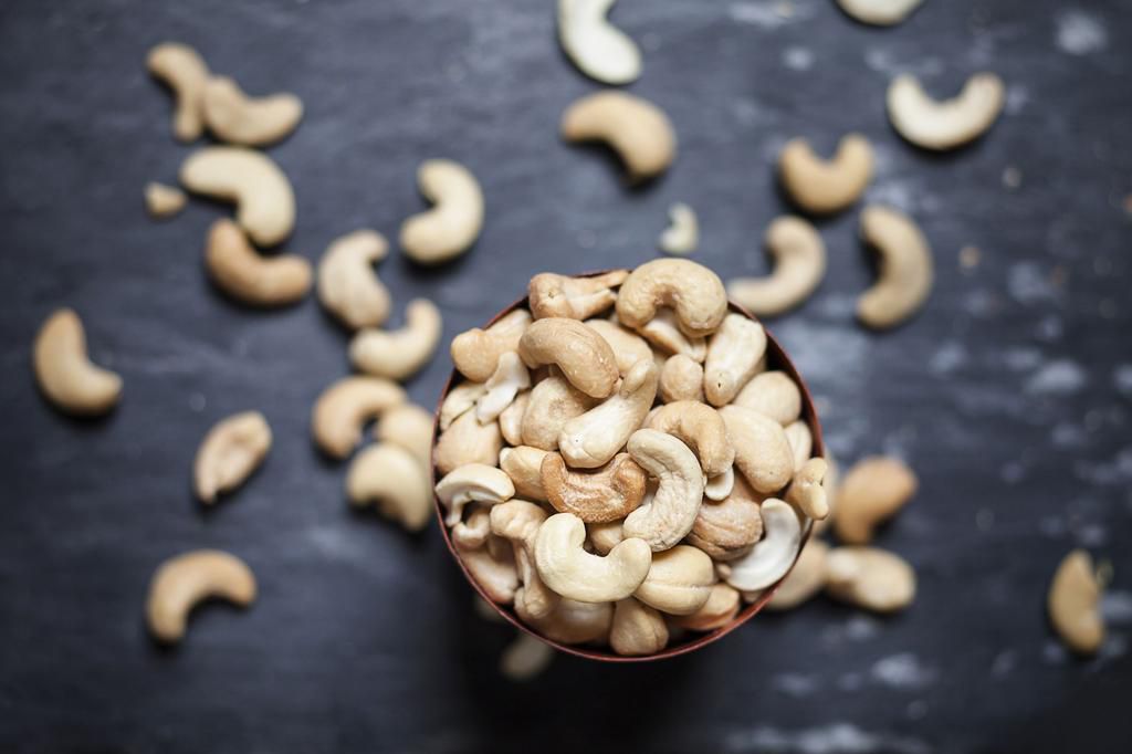 Bowl of roasted and salted cashew nuts on slate