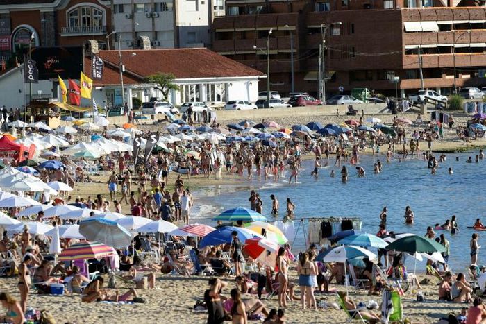 (FILES) In this file photo taken on January 16, 2019, tourists enjoy the sun at La Mansa beach in Punta del Este, Uruguay; Worldwide destinations received 671 million foreign visitors between January and June