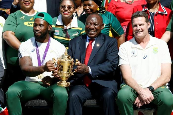 South African President Cyril Ramaphosa holds the Rugby World Cup trophy with Springboks captain Siya Kolisi