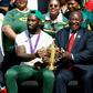 South African President Cyril Ramaphosa holds the Rugby World Cup trophy with Springboks captain Siya Kolisi
