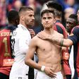 Genoa's Stefano Sturaro (R) comforts forward Paulo Dybala after Juventus suffered their first league defeat of the season.
