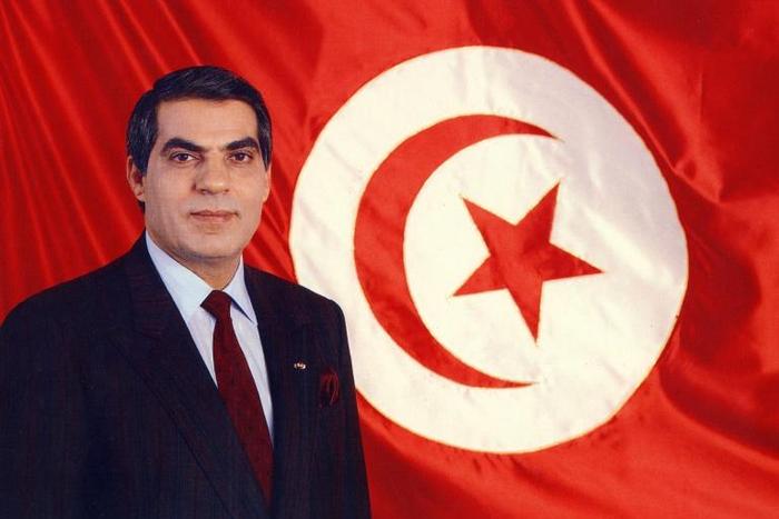 A picture released in April 1998 of Tunisia's ousted president Zine el-Abidine Ben Ali posing for an official picture in front of the Tunisian flag