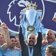 Manchester City manager Pep Guardiola holds the Premier League trophy