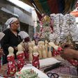 Egyptian women decorate traditional sugar statuettes in the capital Cairo for Al Mawlid Al Nabawi celebrations