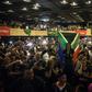 A woman (C) holds a South African flag as a crowd watches the Rugby World Cup final at a Johannesburg theme park last Saturday