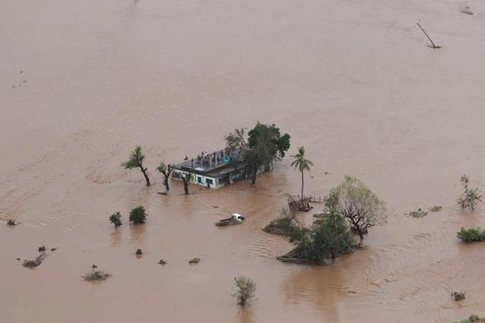 Many people survived the storm and flooding by climbing onto rooftops or up trees where they were waiting to be rescued