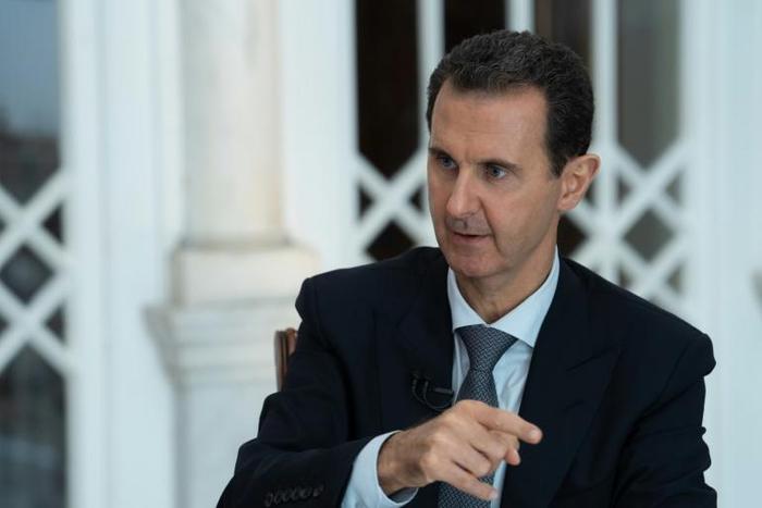 A handout picture released by the official Syrian Arab News Agency (SANA) on October 31, 2019 shows President Bashar al-Assad speaking during a special broadcast interview in Syria's capital Damascus