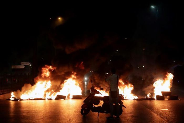 Protesters burned tyres as hundreds of people took to the streets in anger over a move to tax calls on messaging apps