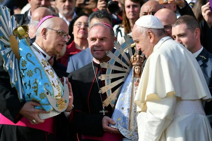 Britain's Bishop of the Forces Paul Mason, left, handed over a statuette of Our Lady of Lujan, Argentina's patron saint, to his Argentine counterpart, Santiago Olivera