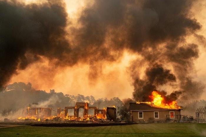 A building at a vineyard is engulfed in flames from the Kincade fire near Geyserville, California on October 24, 2019
