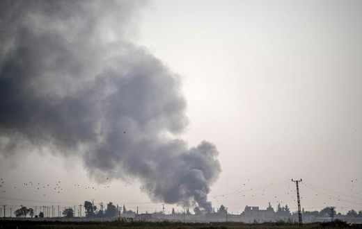 Smoke rises from the Syrian town of Tal Abyad after Turkish bombings