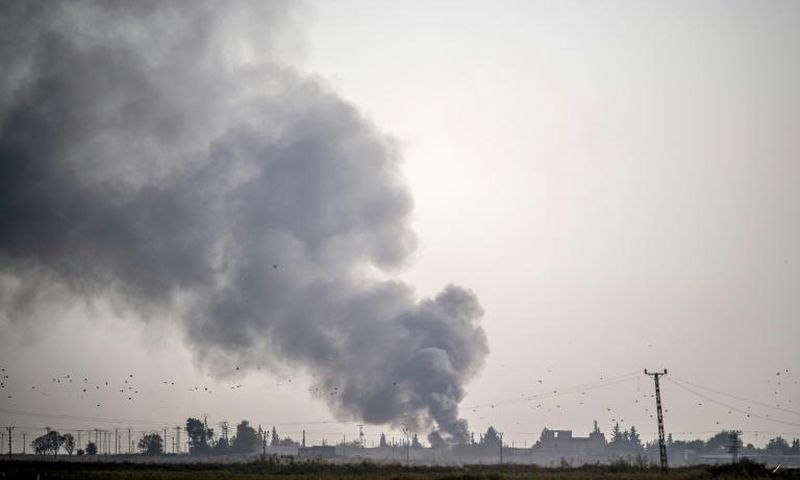 Smoke rises from the Syrian town of Tal Abyad after Turkish bombings