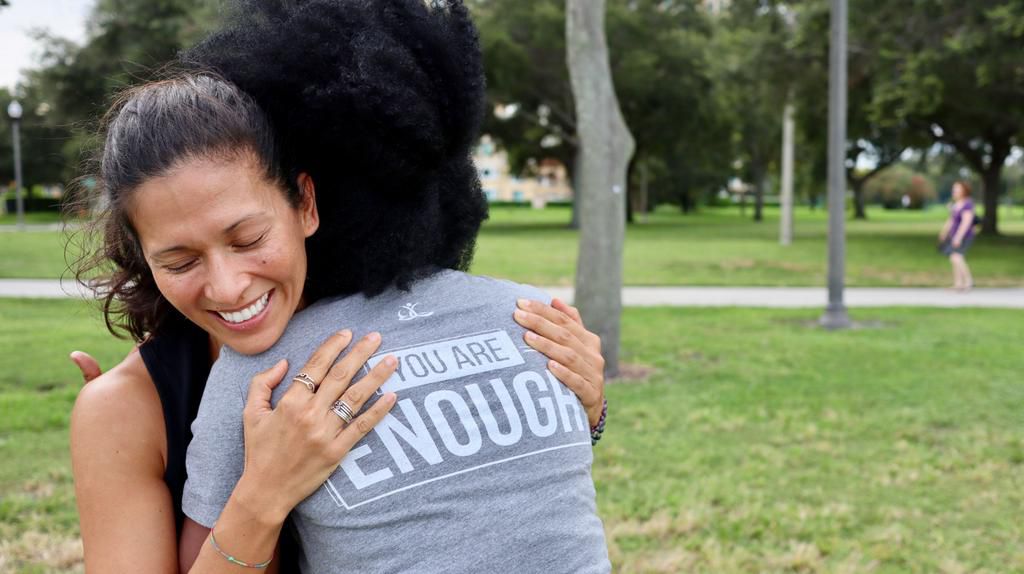 She embraces a pal donning a BackGetters tee.