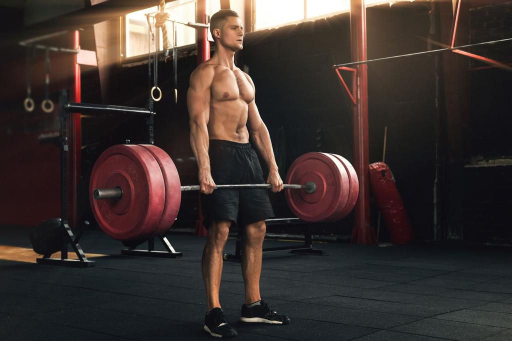Deadlift exercise. Man during his workout in the gym
