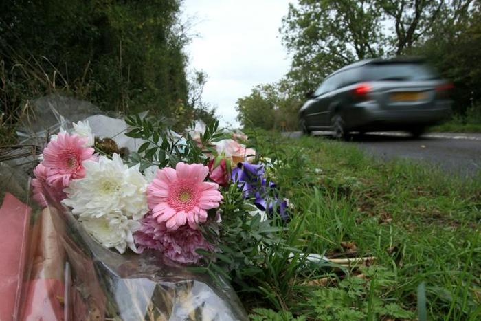 Tributes lie on the roadside near RAF Croughton in Northamptonshire, central England on October 10, 2019, at the spot where Harry Dunn was killed as he travelled along the B4031 on August 27