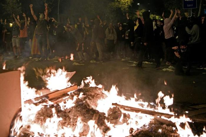 Protesters set fire to barricades during a protest in Barcelona on October 16