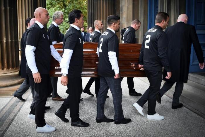 Pallbearers wore number 2 shirts with the name of Fernando Ricksen at his funeral in Glasgow on Wednesday