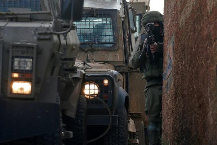 Israeli security forces have launched a manhunt for the assailant who killed two people in the occupied West Bank