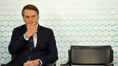 (FILES) In this file photo taken on September 06, 2019, Brazilian President Jair Bolsonaro gestures during the launching ceremony of the new student ID at Planalto Palace in Brasilia