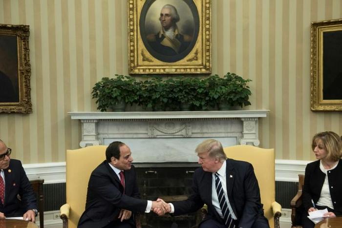 US President Donald Trump (R) shakes hands with his Egyptian counterpart Abdel Fattah al-Sisi in the Oval Office during a meeting on April 3, 2017