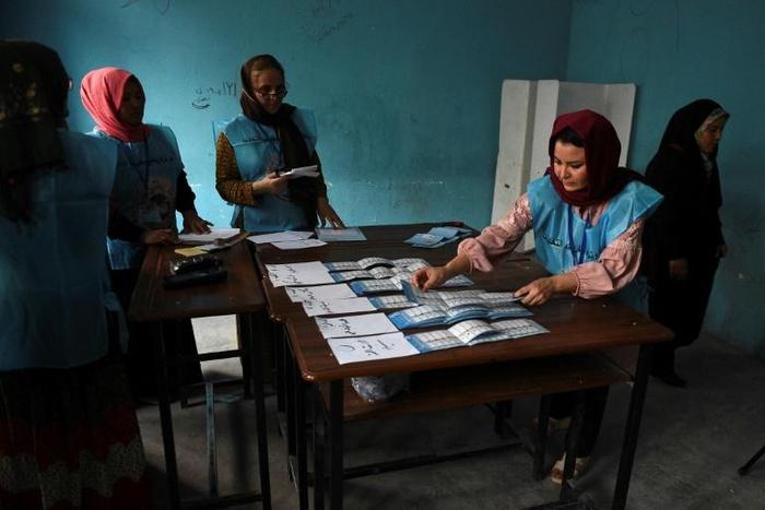 Afghan Independent Election Commission (IEC) officials count ballot papers after polling station closed in Mazar-i- Sharif
