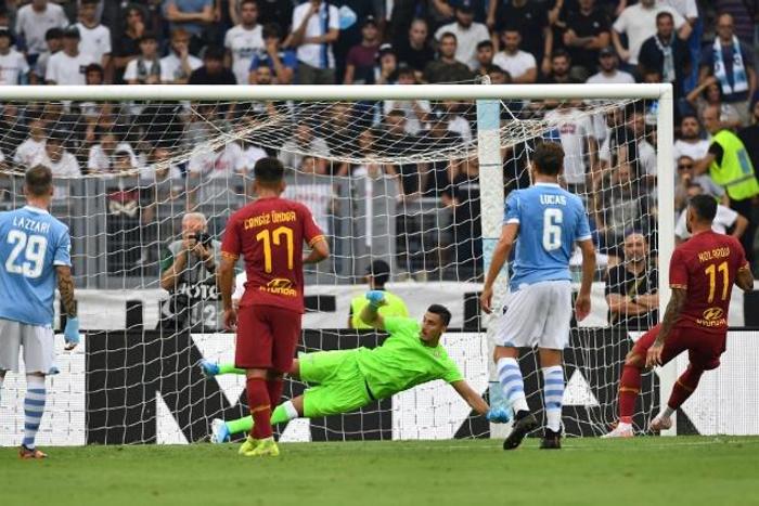 AS Roma's Aleksandar Kolarov (R) scores a penality against Lazio at the Olympic stadium in Rome.