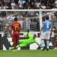AS Roma's Aleksandar Kolarov (R) scores a penality against Lazio at the Olympic stadium in Rome.