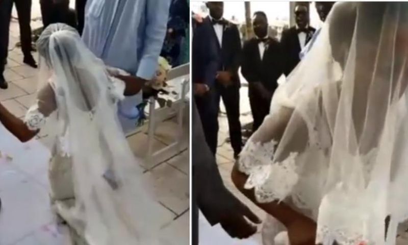 Angry bride walks away from her wedding after kneeling down to apologise to her father
