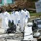 A removal team carries a victim in a body bag on Great Abaco island in the Bahamas