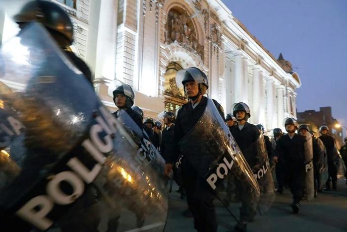 Riot police move into position around the Congress building in Lima after President Martin Vizcarra announced he was dissolving the opposition-dominated legislature