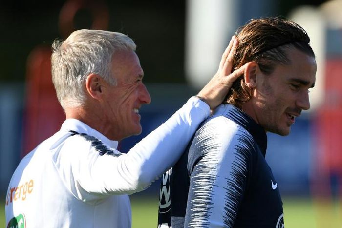 France's head coach Didier Deschamps shares a laugh with forward Antoine Griezmann in training ahead of the Euro 2020 qualifiers