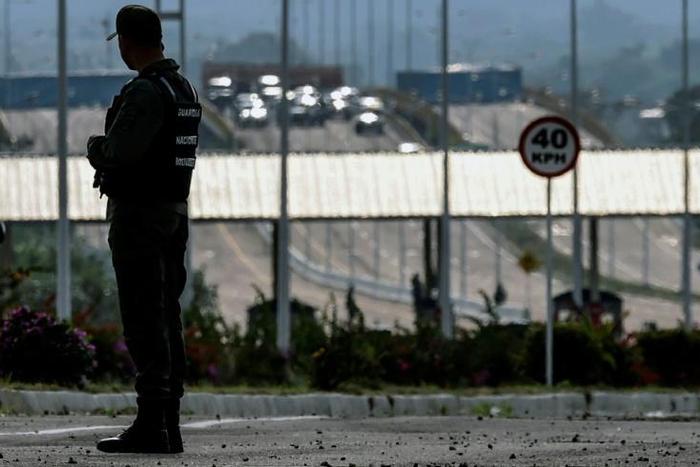 A member of Venezuela's Bolivarian National Guard patrols at the border with Colombia -- the country's opposition is trying to convince more military personnel to switch sides
