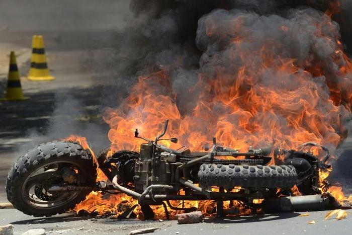 A motorbike burns in Cochabamba, a stronghold of Bolivia President Evo Morales, as clashes between his supporters and those of rival Carlos Mesa continue