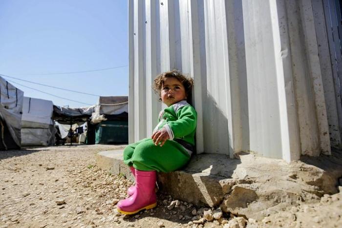 A young Syrian girl is among thousands of child refugees living in camps in Lebanon