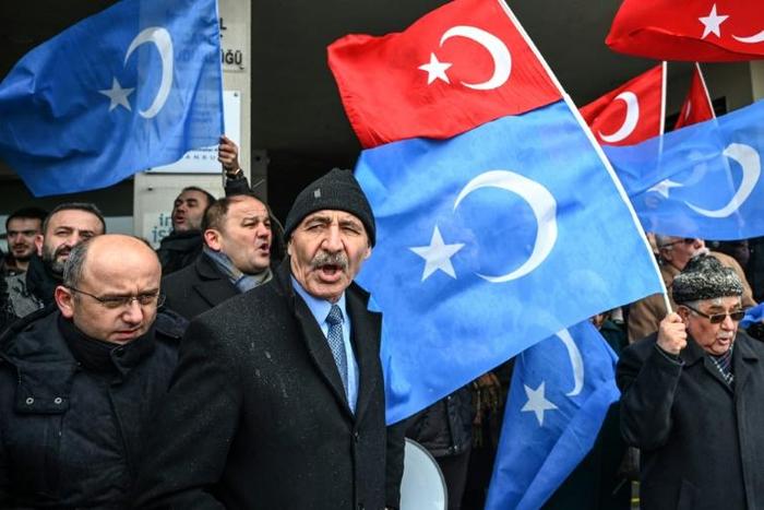 Demonstrators, seen here with Turkish flags and the flags of East Turkistan region used by Uyghur activists, have protested outside the Chinese embassy