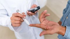 Man checking sugar level with glucometer
