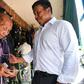 Puea Thai’s party candidate Chadchart Sittipunt talks to a voter in Bangkok