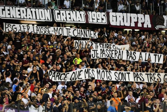 Metz' supporters hold banners that got their match with Paris Saint-Germain halted for three minutes