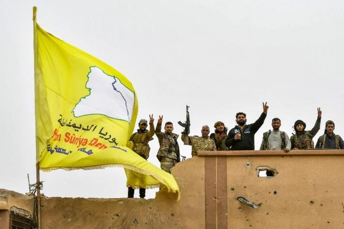 Syrian Kurdish fighters raise their flag in March after overrunning the last vestige of the Islamic Strate group's "caliphate" in a US-backed offensive they had hoped would earn them Western support for their dreams of self-rule