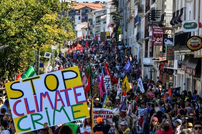 Demonstrators take part in a climate march in Hendaye, south-west France on August 24, 2019, to protest against the annual G7 Summit