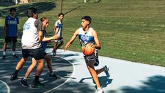 <strong> </strong><strong>SUMMERTIME AT THE SLAB:</strong> Justin Kitcheyan, 15, drives to the hoop. From left: Drew PArker, 18; Ed Payer, 17; Dyami Berridge, 13; and Jamison Smith, 15.