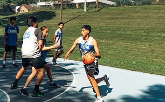 <strong> </strong><strong>SUMMERTIME AT THE SLAB:</strong> Justin Kitcheyan, 15, drives to the hoop. From left: Drew PArker, 18; Ed Payer, 17; Dyami Berridge, 13; and Jamison Smith, 15.