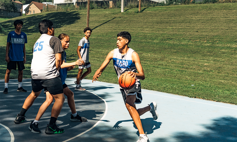 <strong> </strong><strong>SUMMERTIME AT THE SLAB:</strong> Justin Kitcheyan, 15, drives to the hoop. From left: Drew PArker, 18; Ed Payer, 17; Dyami Berridge, 13; and Jamison Smith, 15.