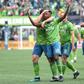 Seattle's Kelvin Leerdam, with arms raised, celebrates with teammates after putting the Sounders ahead on their way to a 3-1 victory over Toronto FC in the MLS Cup final on Sunday