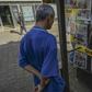 A man looks at the front pages of newspaper in Medellin, Colombia after FARC leaders announced a return to arms